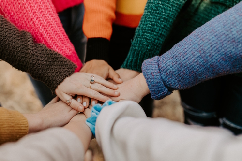 Team of people with hands on top of each other