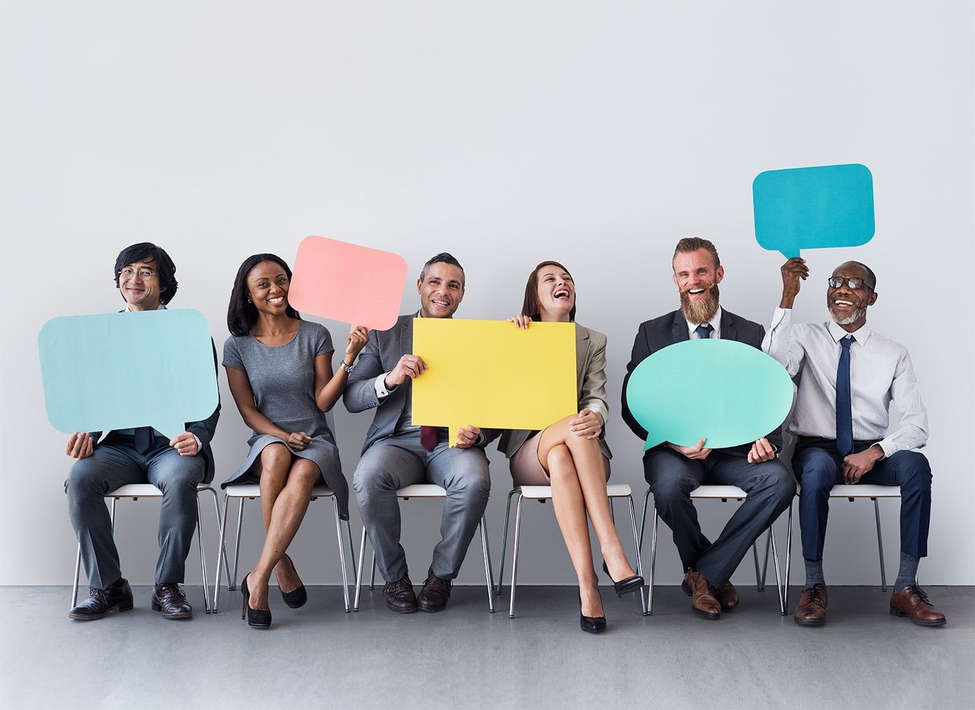 People holding feedback speech bubbles